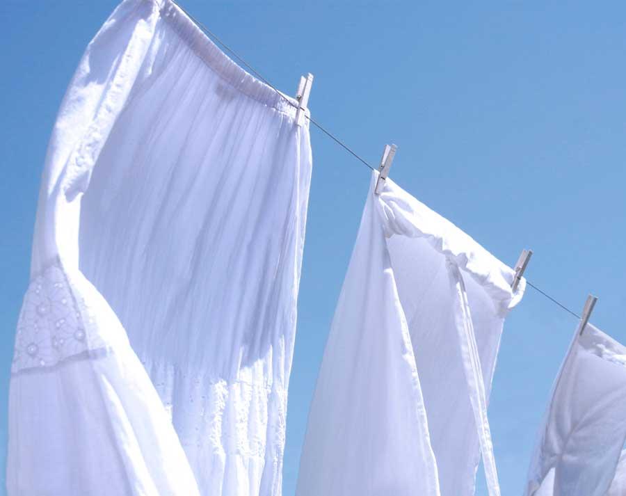 Bright white linens drying on a clothesline